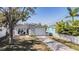 Charming home with a well-maintained lawn, driveway, and covered porch at 4568 67Th N St, St Petersburg, FL 33709