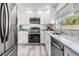 Modern kitchen with stainless steel appliances, granite countertops, and white cabinets at 4568 67Th N St, St Petersburg, FL 33709