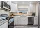 Bright kitchen with white cabinets, stainless steel appliances, and granite countertops at 4568 67Th N St, St Petersburg, FL 33709