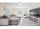 Spacious living area with large windows, comfortable seating, and modern wood-look floors at 4568 67Th N St, St Petersburg, FL 33709