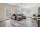 Well-lit living room with comfortable seating, neutral decor, and stylish light-wood flooring at 4568 67Th N St, St Petersburg, FL 33709