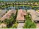 Aerial view of a home near a lake with a well-maintained backyard and tile roof at 4811 Sandy Glen Way, Wimauma, FL 33598