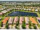 Aerial view of homes surrounding a lake in a residential community, with manicured lawns and landscaping at 4811 Sandy Glen Way, Wimauma, FL 33598