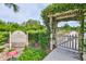 Entrance to community garden surrounded by lush greenery and clear signage for residents at 4811 Sandy Glen Way, Wimauma, FL 33598
