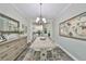 Dining room includes a wooden table and dresser with view to the kitchen at 4811 Sandy Glen Way, Wimauma, FL 33598