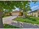 Charming single-story home featuring a well-manicured lawn and a welcoming two-car garage at 4811 Sandy Glen Way, Wimauma, FL 33598