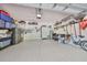 Organized two-car garage with ample storage and a workbench, perfect for projects and hobbies at 4811 Sandy Glen Way, Wimauma, FL 33598