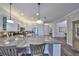 Well-appointed kitchen with granite island and stainless appliances, seamlessly connected to living areas at 4811 Sandy Glen Way, Wimauma, FL 33598