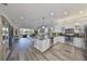 Spacious kitchen with stainless steel appliances, open to the living area and outdoor lanai at 4811 Sandy Glen Way, Wimauma, FL 33598