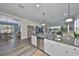 Open concept kitchen with a central island, stainless appliances and adjoining living room at 4811 Sandy Glen Way, Wimauma, FL 33598