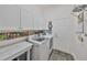 Clean and functional laundry room equipped with modern appliances and ample storage at 4811 Sandy Glen Way, Wimauma, FL 33598