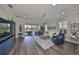 Comfortable living room with lanai access offering lake views, and elegant decor at 4811 Sandy Glen Way, Wimauma, FL 33598