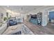 Open concept living room with wood floors, blue accents, and seamless kitchen access at 4811 Sandy Glen Way, Wimauma, FL 33598