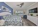 Main bedroom features a large bed and picturesque window views at 4811 Sandy Glen Way, Wimauma, FL 33598