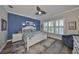 Main bedroom featuring blue accent wall and white furniture with lots of natural light at 4811 Sandy Glen Way, Wimauma, FL 33598