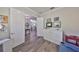 Home office space with gray wood floors, white cabinets, and a door leading to a dining room at 4811 Sandy Glen Way, Wimauma, FL 33598