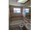 Tiled bathroom featuring bathtub and shower combination, vanity with sink, and a window for natural light at 5130 Tilson Dr, New Port Richey, FL 34652