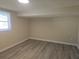 Inviting bedroom with wood-look floors, a window, neutral walls, and clean baseboards for a modern touch at 5130 Tilson Dr, New Port Richey, FL 34652