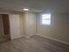 Spacious bedroom with wood-look floors, a window, neutral walls, and closet to left at 5130 Tilson Dr, New Port Richey, FL 34652