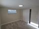 Comfortable bedroom featuring neutral carpet, a window, closet, and crisp white trim for a clean aesthetic at 5130 Tilson Dr, New Port Richey, FL 34652