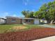 Inviting single-story home featuring a well-maintained lawn and fresh landscaping at 5130 Tilson Dr, New Port Richey, FL 34652