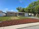Inviting single-story home featuring a well-maintained lawn and fresh landscaping at 5130 Tilson Dr, New Port Richey, FL 34652