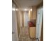 Hallway featuring overhead cabinets with red countertop at 5130 Tilson Dr, New Port Richey, FL 34652