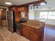 Updated kitchen featuring granite countertops, stainless steel appliances, and rich wood cabinetry at 5130 Tilson Dr, New Port Richey, FL 34652