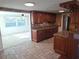 Cozy kitchen boasting granite counters, wood cabinetry, and tile flooring at 5130 Tilson Dr, New Port Richey, FL 34652