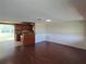 Spacious living room with hardwood floors, flowing into an open-concept kitchen at 5130 Tilson Dr, New Port Richey, FL 34652