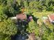 A beautiful aerial view of a home surrounded by tall trees and a spacious lawn at 5454 Saddlebrook Way # 2, Wesley Chapel, FL 33543