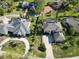 Aerial view of a beautiful home with manicured landscaping and a circular driveway, exuding curb appeal at 5454 Saddlebrook Way # 2, Wesley Chapel, FL 33543
