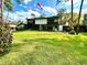 Spacious backyard featuring green lawn space and a screened-in lanai at 5454 Saddlebrook Way # 2, Wesley Chapel, FL 33543