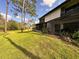 Beautiful green backyard with an enclosed patio and lush landscaping at 5454 Saddlebrook Way # 2, Wesley Chapel, FL 33543