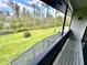 Enjoy a relaxing view of the expansive green lawn and mature trees from this screened-in balcony at 5454 Saddlebrook Way # 2, Wesley Chapel, FL 33543