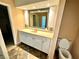This bathroom features a lovely vanity with a sink and ample storage space, along with a nearby toilet at 5454 Saddlebrook Way # 2, Wesley Chapel, FL 33543
