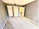 A gray-painted bedroom with a closet and a carpet that adds comfort to the room at 5454 Saddlebrook Way # 2, Wesley Chapel, FL 33543