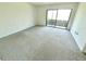 Carpeted bedroom features a sliding door to the outside at 5454 Saddlebrook Way # 2, Wesley Chapel, FL 33543