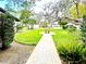 Charming home featuring a well-manicured lawn and inviting walkway to the entrance at 5454 Saddlebrook Way # 2, Wesley Chapel, FL 33543