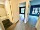 Bright hallway showcasing access to a bathroom and bedrooms with fresh paint and modern flooring choices at 5454 Saddlebrook Way # 2, Wesley Chapel, FL 33543