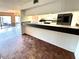 Open-concept layout featuring a breakfast bar that connects the kitchen to the dining area at 5454 Saddlebrook Way # 2, Wesley Chapel, FL 33543