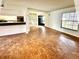 Bright living room with parquet floors, bar counter, and an open entryway with natural light at 5454 Saddlebrook Way # 2, Wesley Chapel, FL 33543