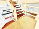 Unique staircase design with wood steps, white railings, and views of the nearby kitchen at 5454 Saddlebrook Way # 2, Wesley Chapel, FL 33543