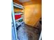 Small storage closet with shelving for organized storage, featuring yellow interior walls at 5454 Saddlebrook Way # 2, Wesley Chapel, FL 33543