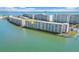 Aerial view of condo building and surrounding waterfront showing location of unit indicated by the yellow arrow at 6075 Shore S Blvd # 509, Gulfport, FL 33707