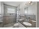 Bathroom featuring tiled shower with decorative accents, granite counters, and modern fixtures at 6075 Shore S Blvd # 509, Gulfport, FL 33707