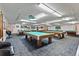 Large billiard room with multiple pool tables under bright lighting perfect for entertainment at 6075 Shore S Blvd # 509, Gulfport, FL 33707