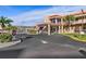 Exterior view of the clubhouse with covered entrance, landscaped beds and ample parking space at 6075 Shore S Blvd # 509, Gulfport, FL 33707