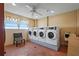 Community laundry room with multiple machines, natural light and a ceiling fan at 6075 Shore S Blvd # 509, Gulfport, FL 33707