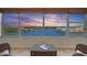 Breathtaking water view from the condo with a picturesque sunset and comfortable seating area at 6075 Shore S Blvd # 509, Gulfport, FL 33707